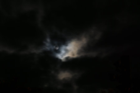 Photo of night cloudy sky and moon, defocused background. Not an illustration.