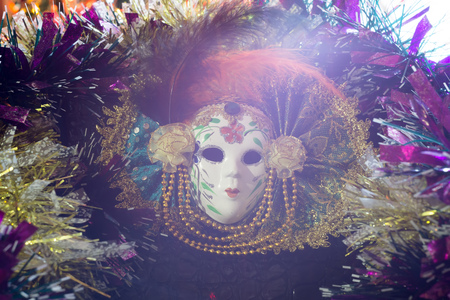Carnival mask with feathers on a background of holiday lights.の写真素材