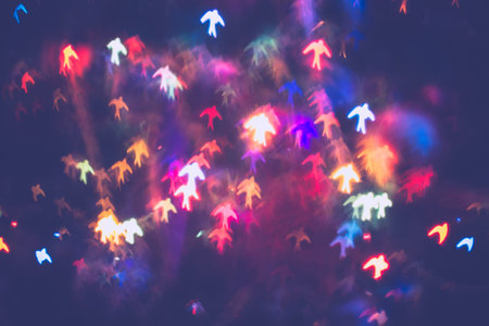 Festive background with bird shaped bokeh from Christmas tree lights glowing.の写真素材