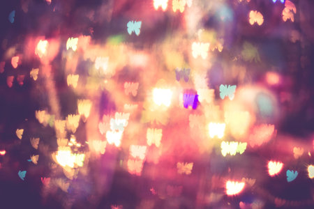 Festive background with butterfly shaped bokeh from Christmas tree lights glowing.の写真素材