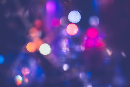 Festive background with bokeh from Christmas tree lights glowing.