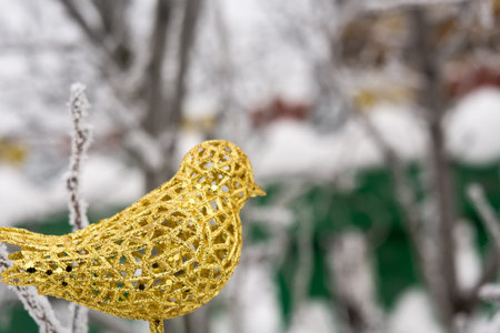 Decorative element artificial glittering golden bird, ornamental Christmas toyの写真素材