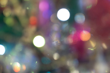 Festive background with bokeh from Christmas tree lights glowing.