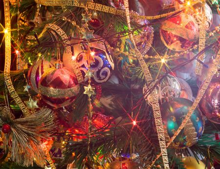 Close up of Christmas or New Year fir tree with decorative lights and toys.の写真素材