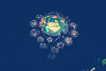 Fashion ring decorated with white fire opal stones, filtered background.