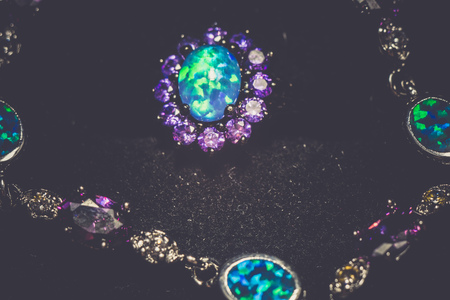 Fashion ring decorated with blue fire opal stones, filtered background.の写真素材