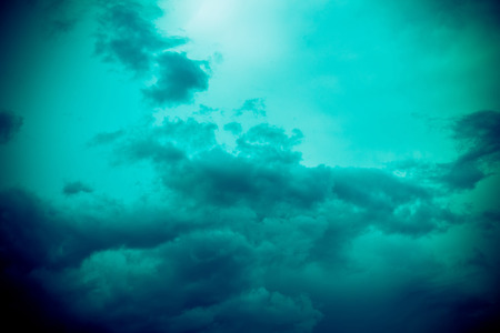 Dramatic stormy black sky clouds before rain, filtered natural background.の写真素材