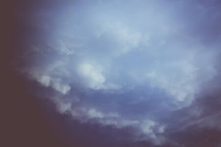 Dramatic stormy dark sky clouds before rain, filtered natural background.の写真素材