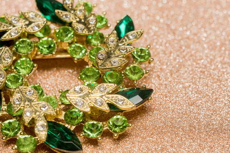 Brooch in a shape of a flower decorated with green rhinestones, fashion jewellery.の写真素材
