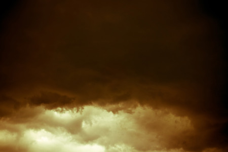 Dramatic stormy black sky clouds before rain, filtered natural background.の写真素材