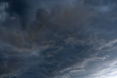 Dramatic stormy black sky clouds before rain, natural background.の写真素材