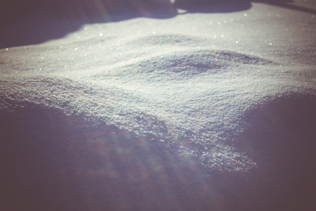 Close up of fresh white snow, snowy hills filtered background.