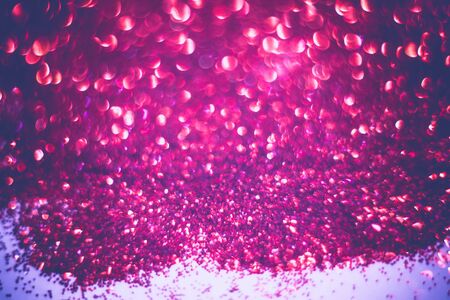Defocused glitter as filtered background with circular bokeh of red color.の写真素材