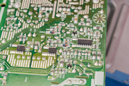 Green electric circuit board, close up background.
