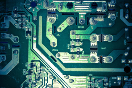 Green electric circuit board, close up background.