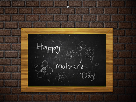 Illustration of Happy Mother's Day written on a black chalkboard.の写真素材