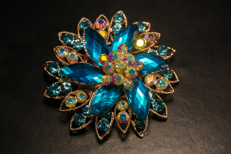 Decorative fashion flower shaped brooch with blue stones.の写真素材