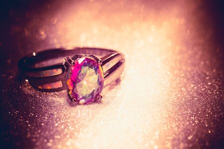 Fashion ring with mystic topaz, rainbow topaz, modern jewelry, filtered background.の写真素材