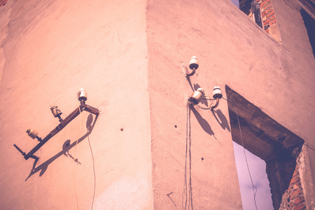 Old crumbling brick house, walls of abandoned building filtered background.の写真素材