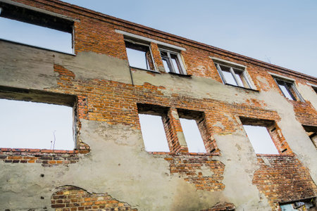 Old crumbling brick house, abandoned building background.