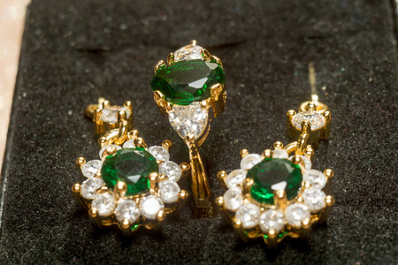 Elegant female jewelry golden ring with precious green gem, emerald.の写真素材