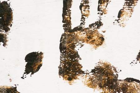 Grunge brown handprint on white painted rectangle surface.の写真素材