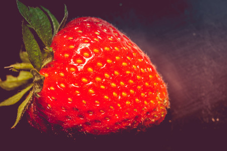 Juicy fresh red strawberry close up vintage background.の写真素材