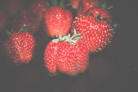 Juicy fresh red strawberry close up vintage background.の写真素材