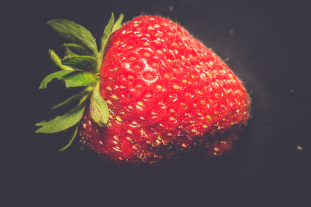 Juicy fresh red strawberry close up vintage background.の写真素材