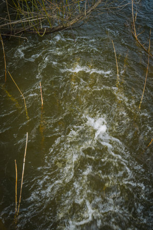 Close up background of fast flowing water in the rural river.の写真素材