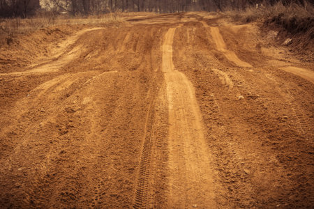 Trail of treads on a sandy quarry retro background.