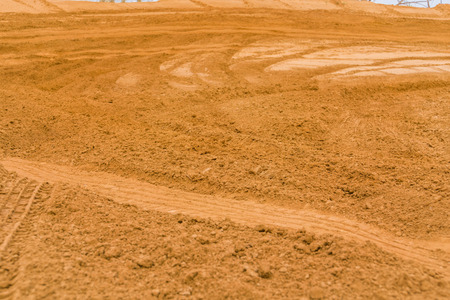 Trail of treads on a sandy quarry background.の写真素材