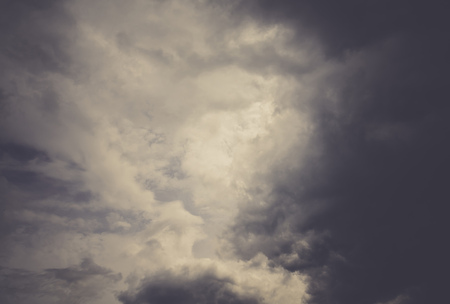 Dark sky with heavy stormy clouds, filtered natural background.の写真素材