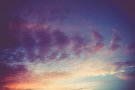 Summer sunset sky with clouds of red color, filtered background.の写真素材