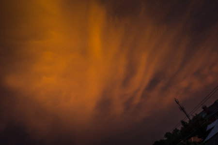 Summer sunset sky with clouds of red color.
