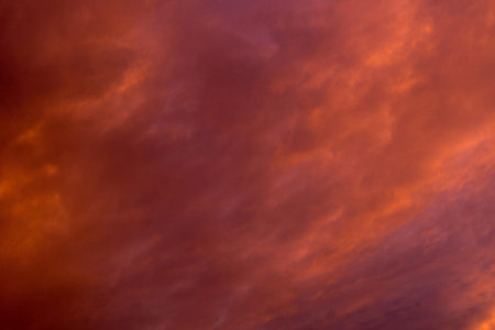 Summer sunset sky with clouds of red color.