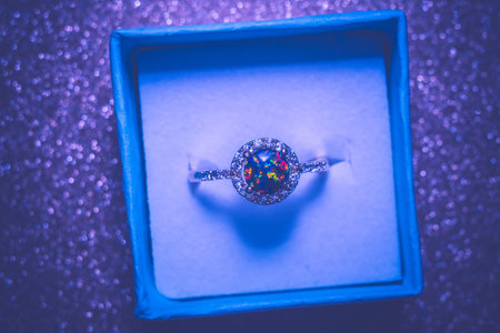 Fashion golden ring with synthetic fire opal stone of green color.