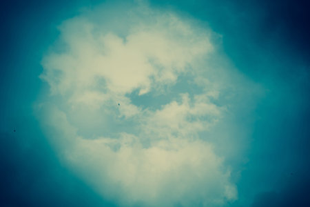 Dark sky with heavy stormy clouds, filtered natural background.