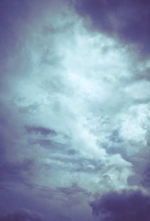 Dark sky with heavy stormy clouds, filtered natural background.の写真素材