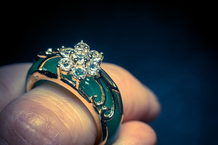 Green jade ring decorated with diamonds and gold setting.の写真素材