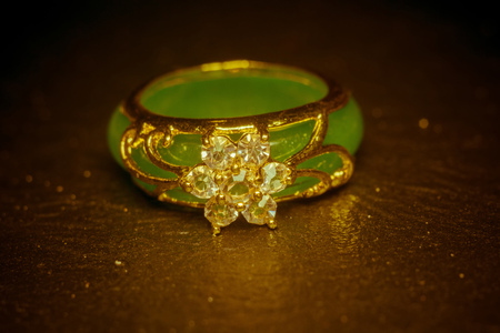 Green jade ring decorated with diamonds and gold setting.の写真素材