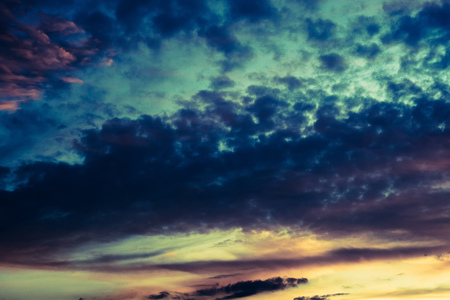 Summer sunset sky with clouds of red color, filtered background.の写真素材