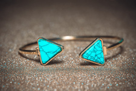 Vintage gold bracelet with blue turquoise, modern geometric shapes.