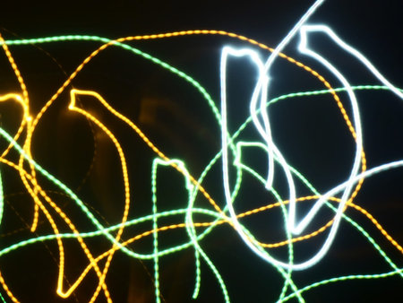 Colorful light streaks glowing on black background.