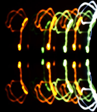 Colorful light streaks glowing on black background.