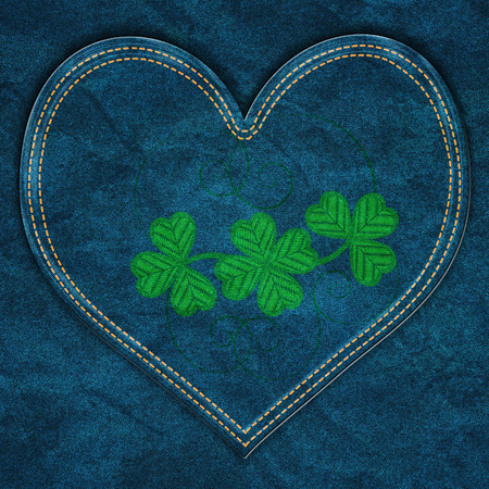 Green shamrock or clover embroidered on a denim background.の写真素材