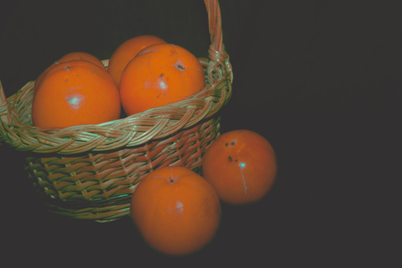 Delicious ripe persimmon, juicy orange fruits on black background, filtered.の写真素材