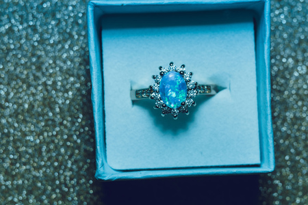Fashion golden ring decorated with blue fire opal stones.の写真素材