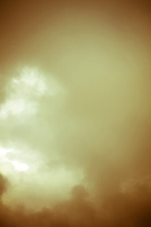 Heavy grey clouds in the sky before the rain filtered.の写真素材