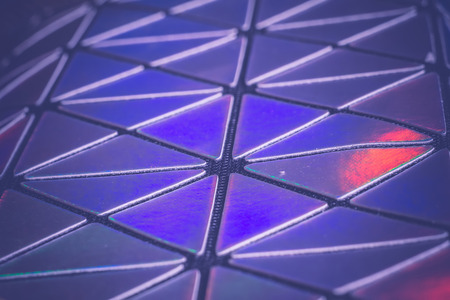 Modern iridescent triangular texture as abstract background, filtered macro.の写真素材